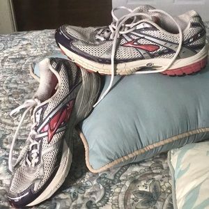 Brooks athletic shoes in white, pink, and silver.  They have been worn.